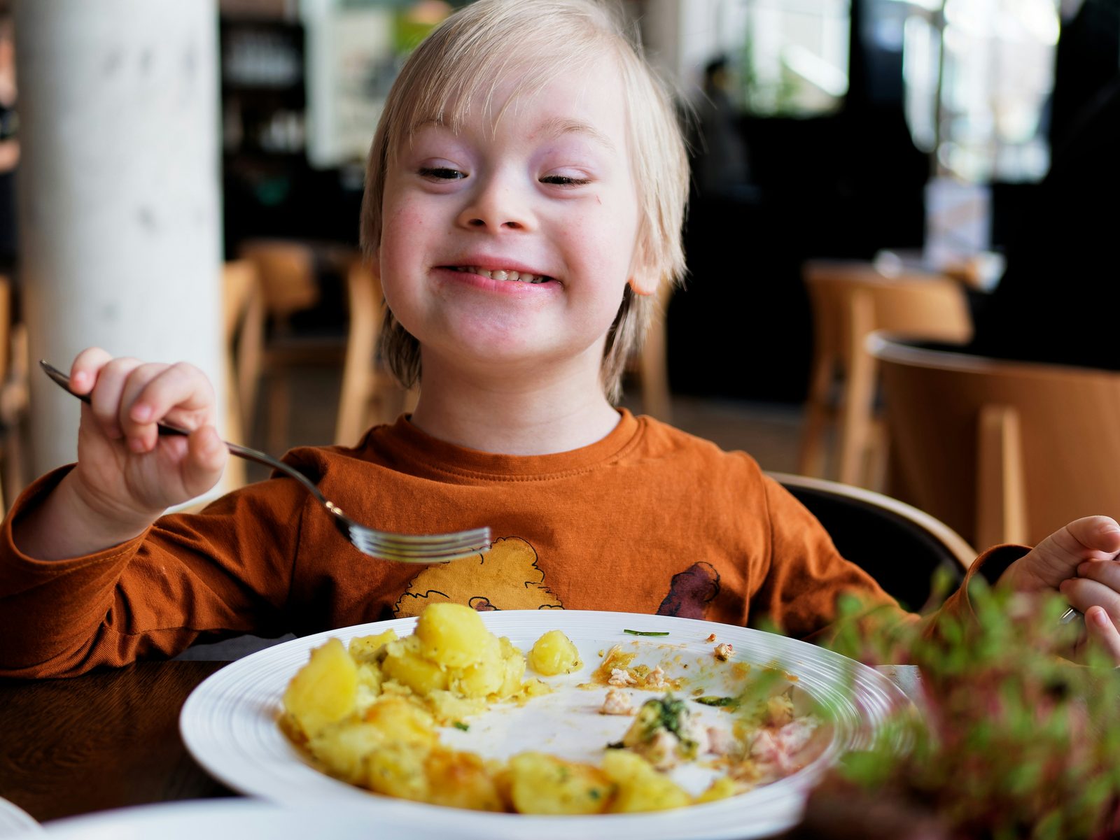 A child enjoying a meal out with family