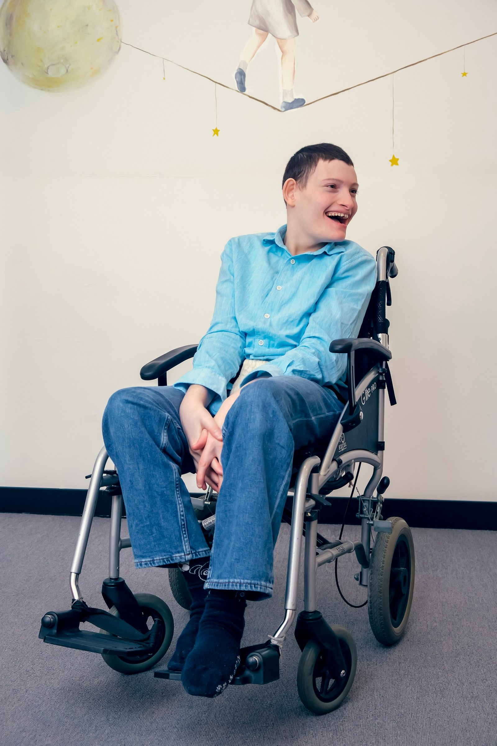 A participant smiling in his wheelchair