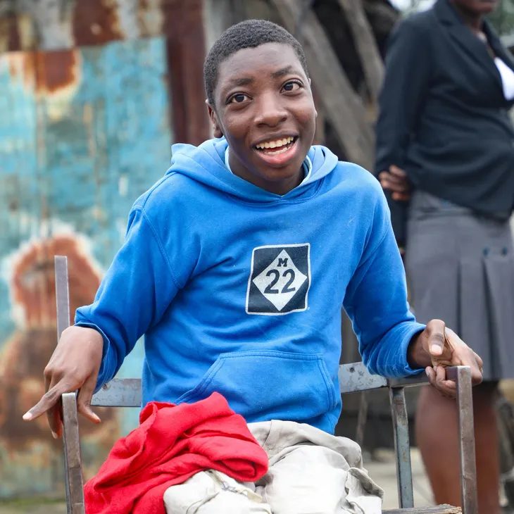 A caregiver smiling outdoors